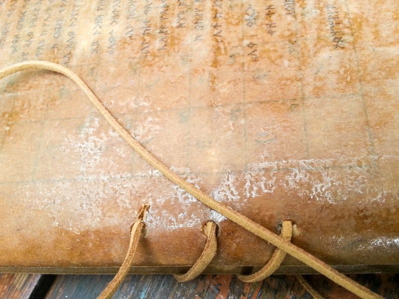 Bind the pages together with leather cord sewn through the holes