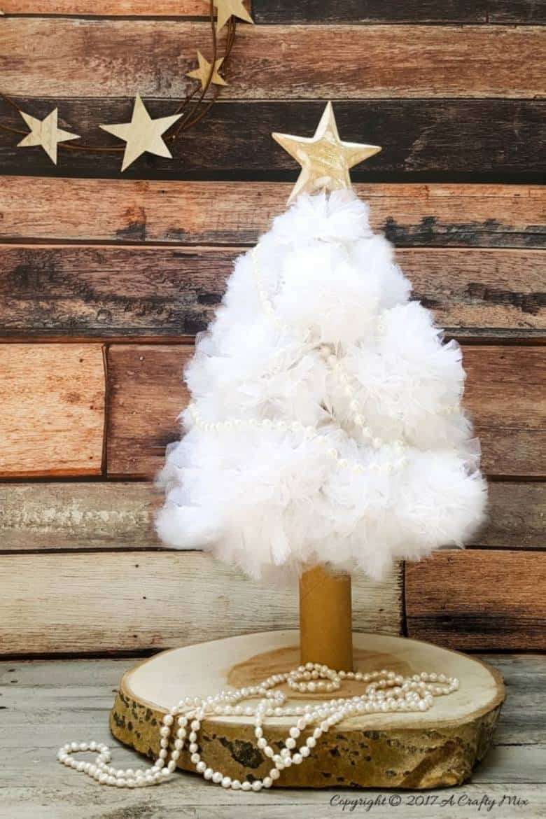 A quick and easy cat proof pom pom Christmas tree. I love how pretty it looks when it lights up at night. Christmas tree alternative ideas to make yourself #DIYChristmasTree #AlternativeChristmasTree #AcraftyMix #EasyCraftIdea #Christmas Decor