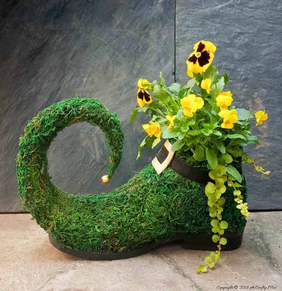 This adorable lucky leprechaun shoe planter is perfect for St. Patrick's day. Quick and easy to make, it will add some festive cheer all year round.. ACraftyMix.com #SpringTrend #StPatricksDay #ShoePlanter #ShoeUpcycle #Repurposed