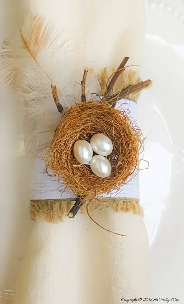 An easy and budget friendly craft tutorial for DIY Bird’s nest Napkin Rings using recycled materials is an inexpensive and beautiful way to make your own napkin ring holders!