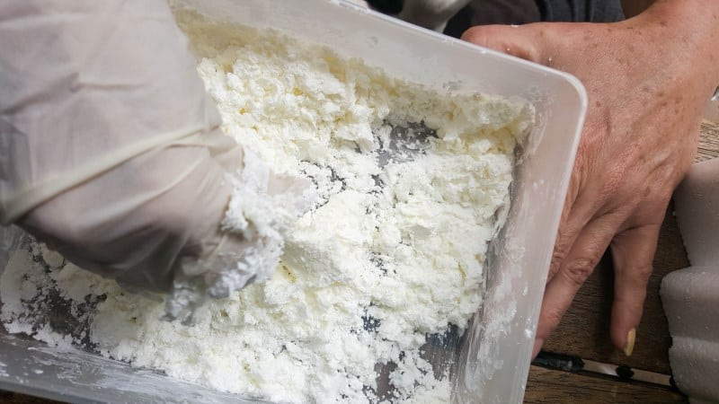 Hand mixing the silicone and corn flour to make the mold