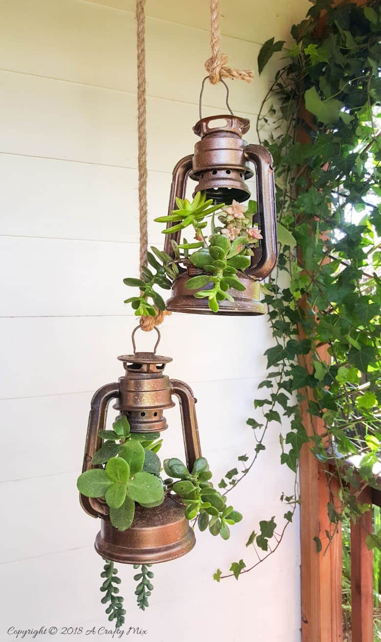 These charming old school lantern planters look amazing hanging on our porch. This tutorial will show you how to make your own pulley from scratch and convert lanterns into planters. It's easy once you now how. 