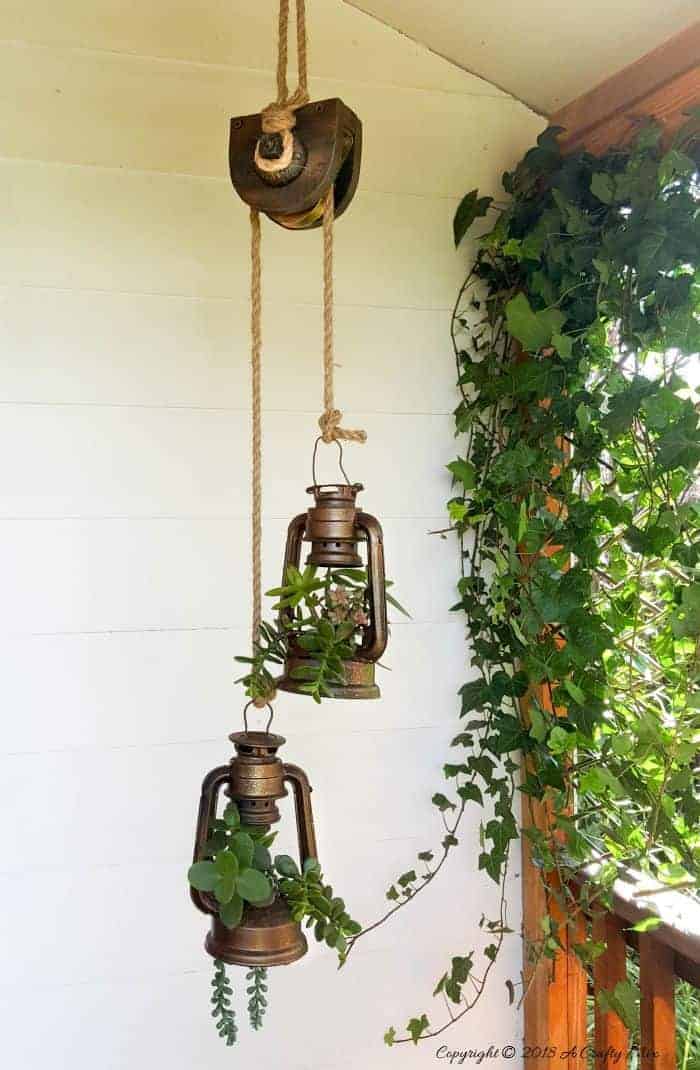 These charming old school lantern planters look amazing hanging from an antique pulley. Make your own with this super tutorial.