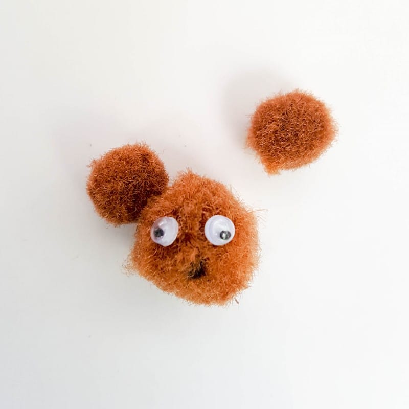 Glue the pompom ears on