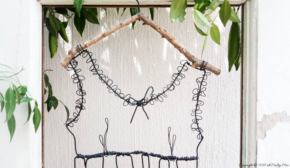 Add little elegance and whimsy to your wall art with this DIY wire dress tutorial. Made from jewelry wire, it's rustic and fun to do. Includes dress template and instructions for printing. Can be hung indoors or out. #WireArt #DIYTutorial #WallDecor