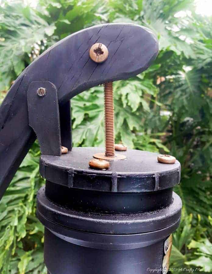 How to make your own faux antique hand water pump with metal patent stamp. #paintingPVCPipes #DIYPaintingPVC #acraftymix #DIYTutorial #fauxhandwaterpump #antiquewaterpump