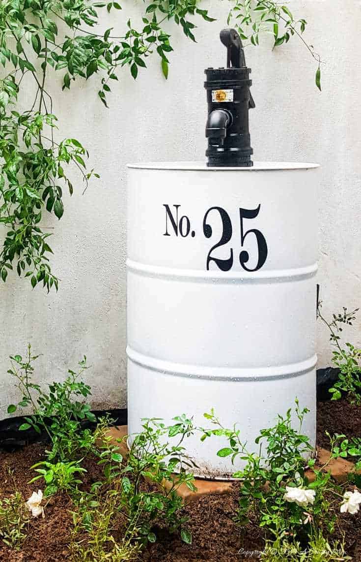 How to turn an empty drum into a unique water feature complete with a faux hand water pump made from PVC pipes. Great curb appeal and easy to follow tutorial  #drumwaterfeature #PVChandpump #DIYTutorial #ACraftyMix