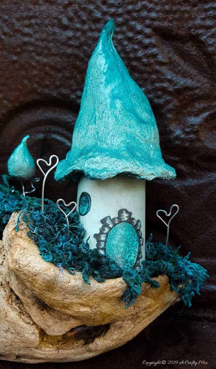 A little fairy home made from a cardboard tube and cotton wool. Add a few whoville inspired Truffula trees to make an unusual fairy scape #FairyGarden #FairyScape #FairyTutorial #ACraftyMix #CraftTutorial #FairyCraft