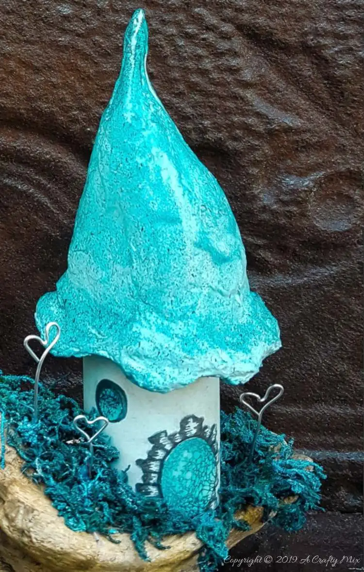 A little fairy home made from a cardboard tube and cotton wool. Add a few Whoville inspired Truffula trees to make an unusual fairy scape #FairyGarden #FairyScape #FairyTutorial #ACraftyMix #CraftTutorial #FairyCraft
