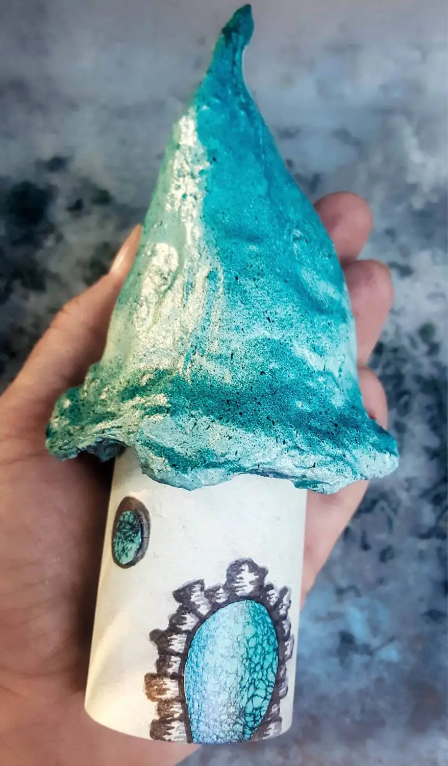 The the baked cotton roof onto the cardboard tube of the Lorax house