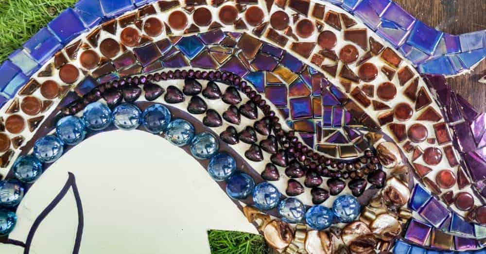 The mosaic tiles and beads have all been glued down and ready to grout #mosaicprojects #tipsandtricks #howtomake #mixedmediamosaic #acraftymix #unicornspit #mosaicart #mosaicideas #unicornart