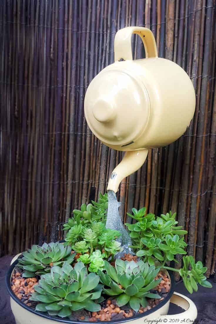 Love the way the "water" seems to flow from the floating teapot into the succulents. Come see how to make your own #SucculentPlanter #FloatingTeapot #ACraftyMix #DIYTutorial #ForkRepurpose #CrazyCrafts