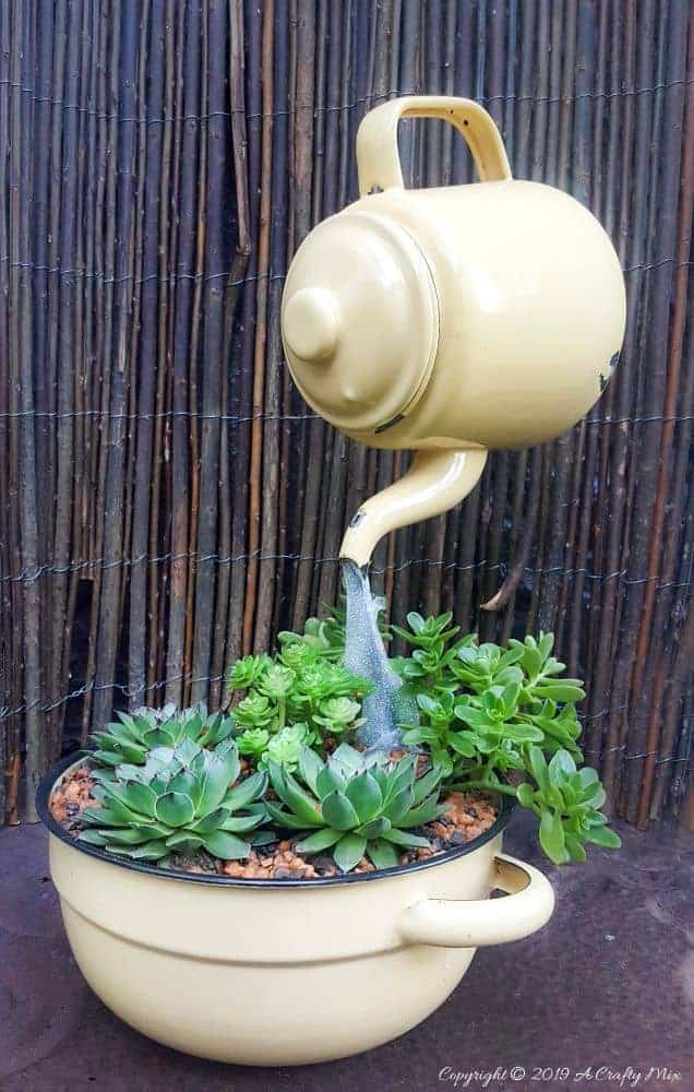 Love the way the "water" seems to flow from the floating teapot into the succulents. Come see how to make your own #SucculentPlanter #FloatingTeapot #ACraftyMix #DIYTutorial #ForkRepurpose #CrazyCrafts