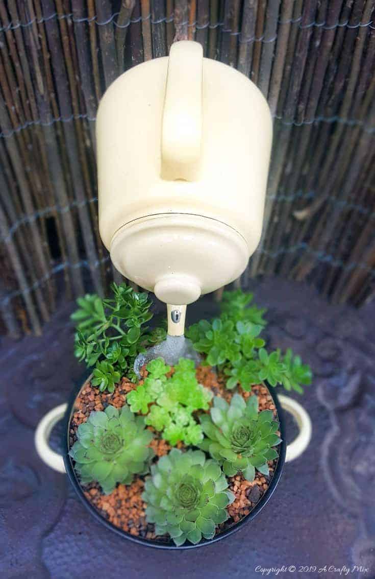 A crazy cool floating teapot planter viewed from the top. Come see how to make your own #SucculentPlanter #FloatingTeapot #ACraftyMix #DIYTutorial #ForkRepurpose #CrazyCrafts
