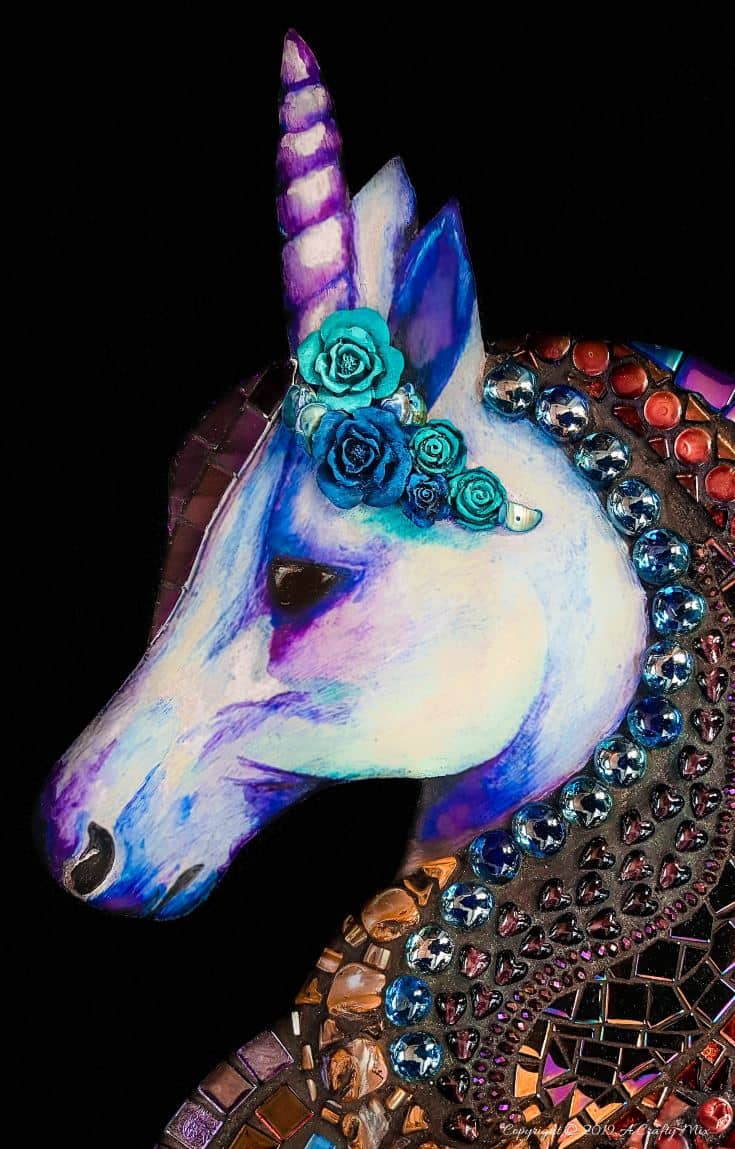 A close up of the unicorn's face. It's been painted with unicorn SPiT. Love the different colors in the mosaic man #mosaicprojects #tipsandtricks #howtomake #mixedmediamosaic #acraftymix #unicornspit #mosaicart #mosaicideas #unicornart