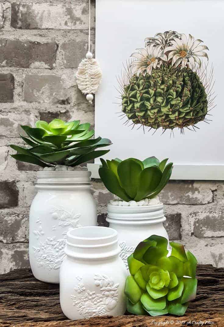 How to make your own set of succulent mason jar canisters! Perfect for your kitchen or bathroom and succulents are so trendy right now, #masonjarcanisters #masonjarcanisterset #kichendecor #masonjar #masonjarcrafts #bathroomdecor #homedecor #rustic #farmhouse #succulent #storage #acraftymix