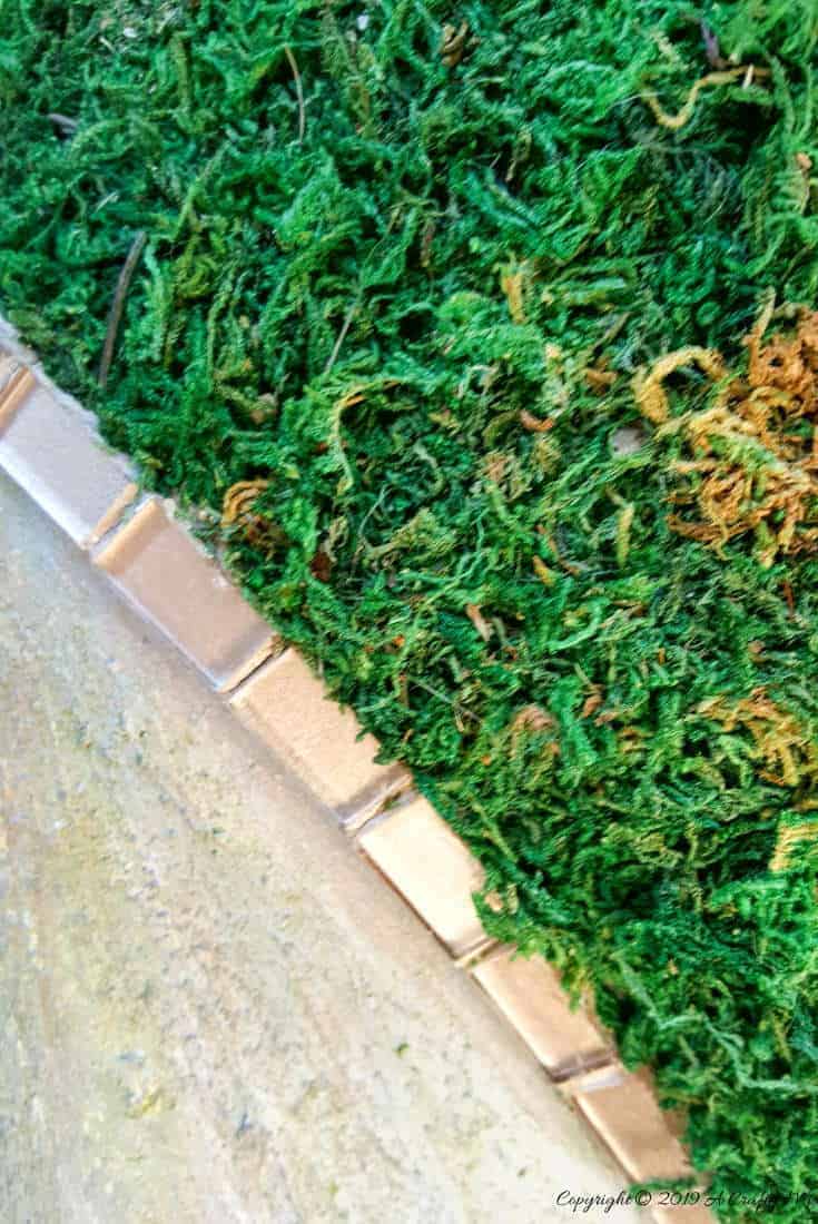 Full tutorial to make a moss mannequin and how to get the faux concrete look. A close up view of leg area and the mosaic tiles. #Fauxconcrete #painteffects #mossmannequin #DIYTutorial #mosseffects #gardenart #acraftymix #recyclegardenart