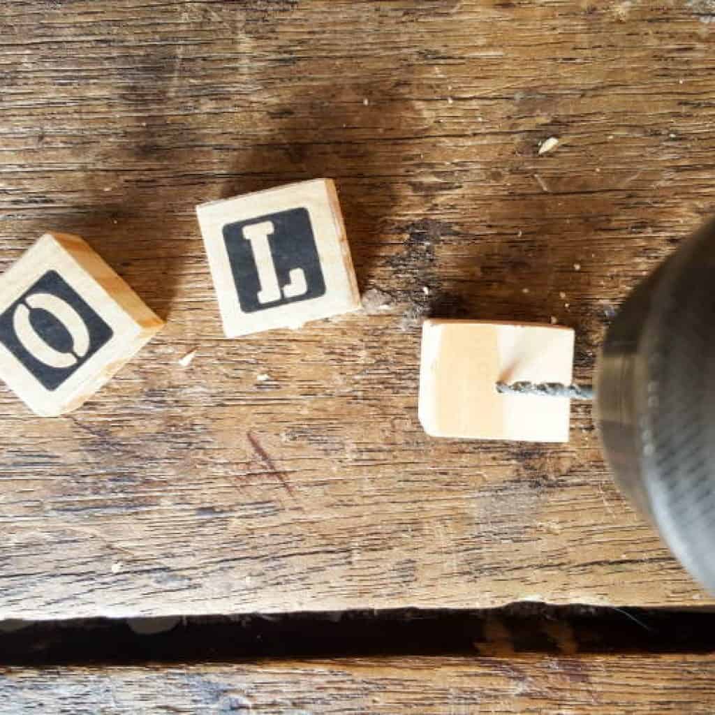 Drill holes in the blocks to make a simple and fun photo display for your Instagram pics #photodisplay #diy #diyproject #photodisplay #familyphotos #home #homedecor #acraftymix #instagramphotos #instax