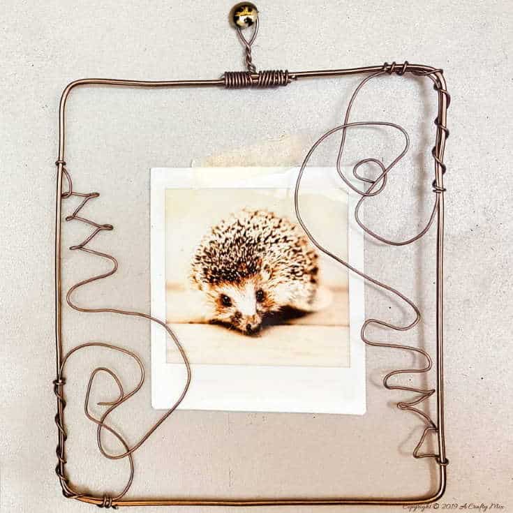 Display your polaroid photos in this DIY wire picture frame. Step-by-step tutorial! #pictureframesDIY #wirepictureframe #pictureframes #gallerywall #creativepictureframes #polaroid #Fujifilm #Instax