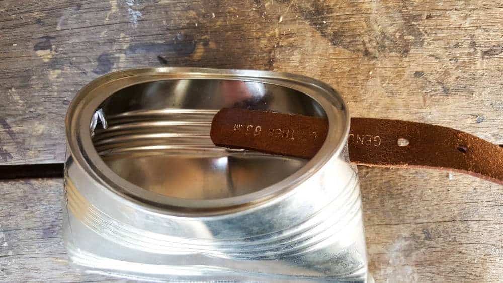 Slip the belt inside the hole you made earlier. #tincan #recycle #repurpose #tincanrecycle #tincanplanter #acraftymix #creativetincanprojects #uniquetincanDIY