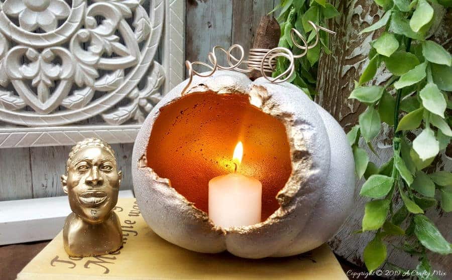 These gorgeous hollow concrete pumpkins will make a lovely addition to your fall d&eacute;cor. You can add a candle or turn them into fun planters. The DIY tutorial is easy to follow so you can make your own. #concretepumpkin #fallcrafts #fallDIY #candleholders #pumpkindecorating