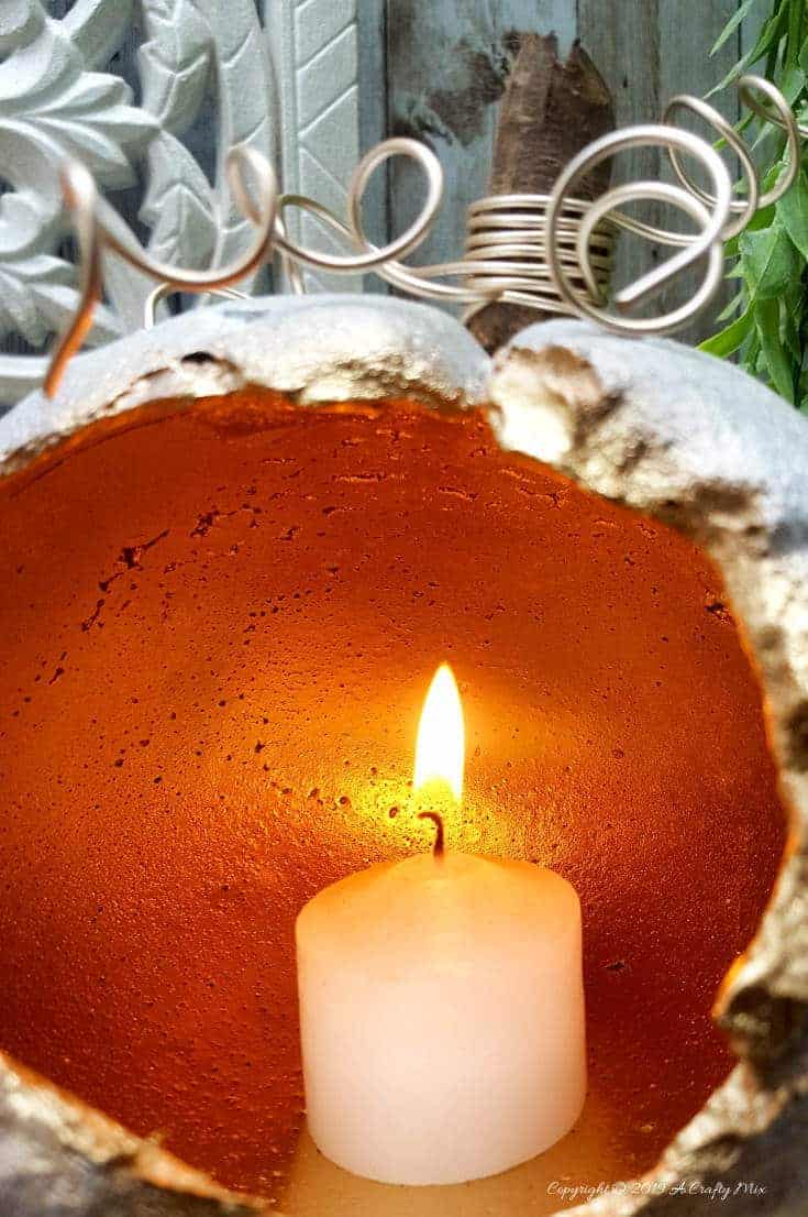 These gorgeous hollow concrete pumpkins will make a lovely addition to your fall d&eacute;cor. You can add a candle or turn them into fun planters. The DIY tutorial is easy to follow so you can make your own. #concretepumpkin #fallcrafts #fallDIY #candleholders #pumpkindecorating