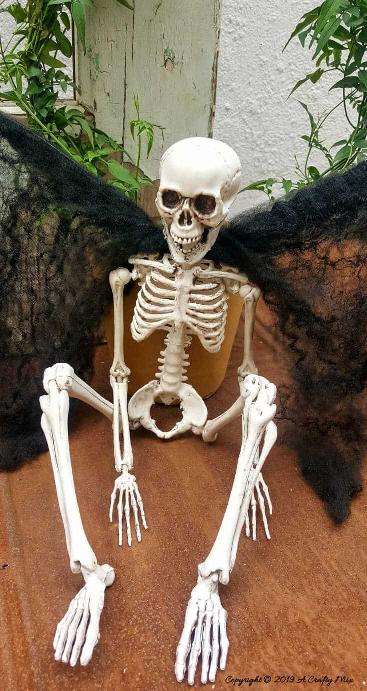 Sergeant Skullie looks like he's having the time of his life with his easy to make vampire wings. #ACraftyMix #FunHalloweenCraft #EasyHalloweenCraft #HalloweenDIY #HalloweenCraft #HolidayCraft