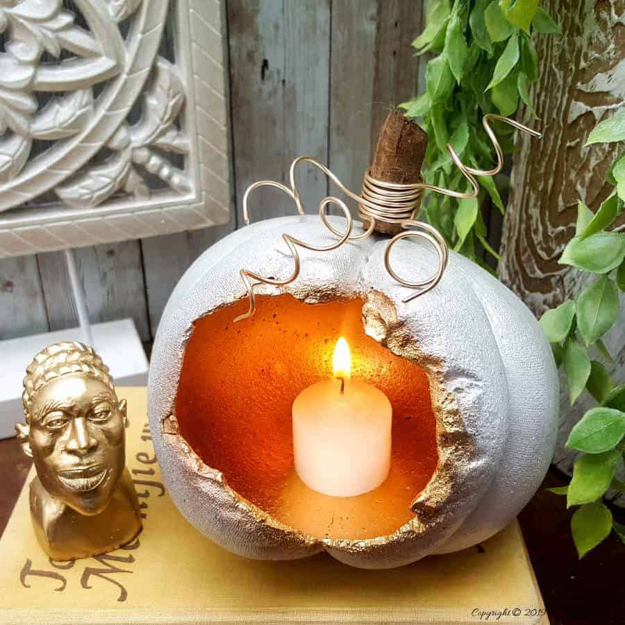 These gorgeous hollow concrete pumpkins will make a lovely addition to your fall d&eacute;cor. You can add a candle or turn them into fun planters. The DIY tutorial is easy to follow so you can make your own. #concretepumpkin #fallcrafts #acraftymix #fallDIY #candleholders