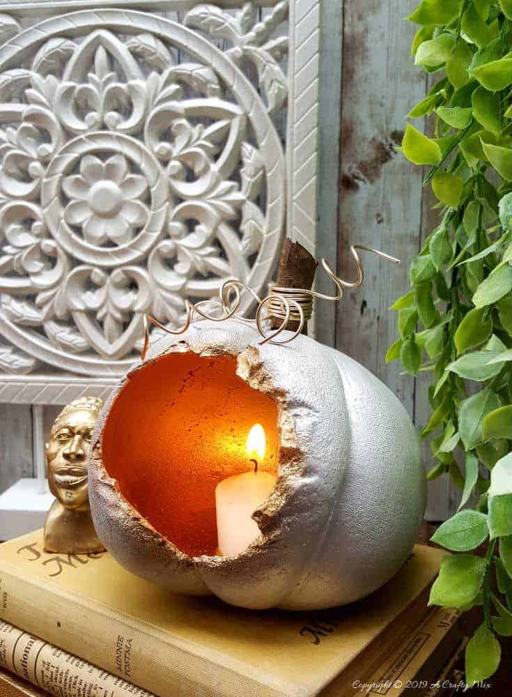 These gorgeous hollow concrete pumpkins will make a lovely addition to your fall d&eacute;cor. You can add a candle or turn them into fun planters. The DIY tutorial is easy to follow so you can make your own. #concretepumpkin #fallcrafts #acraftymix #fallDIY #candleholders