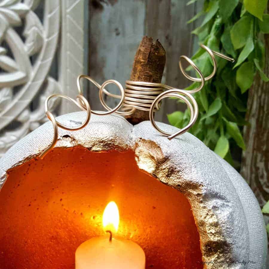 These gorgeous hollow concrete pumpkins will make a lovely addition to your fall d&eacute;cor. You can add a candle or turn them into fun planters. The DIY tutorial is easy to follow so you can make your own. #concretepumpkin #fallcrafts #fallDIY #candleholders #pumpkindecorating