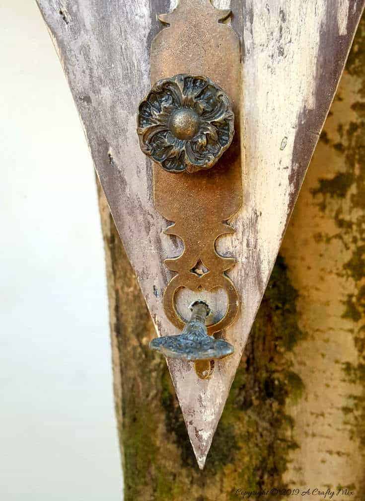 A rusty key for a perch. Want to add some rusty curb appeal or improve your backyard? This unique recycled birdhouse is made entirely from scrap bits and has so much character. It&rsquo;s inexpensive and easy to make too The tutorial includes all the instructions to make your own. #rusticbirdhouse #DIYbirdhouse #paintedbirdhouse #acraftymix #birdhouseideas #uniquebirdhouse