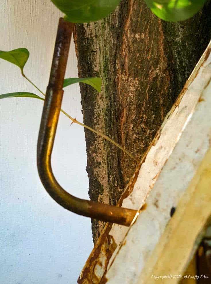 A bent copper pipe makes a great chimney for the recycled birdhouse