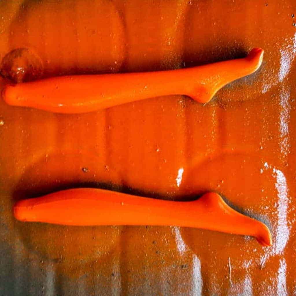 Paint the legs a bright happy orange. #Halloweendecor #dollmakeover #spidergirl #acraftymix #halloweentutorial #halloweenDIY #witchlegs #grandinroad #miniaturehalloween