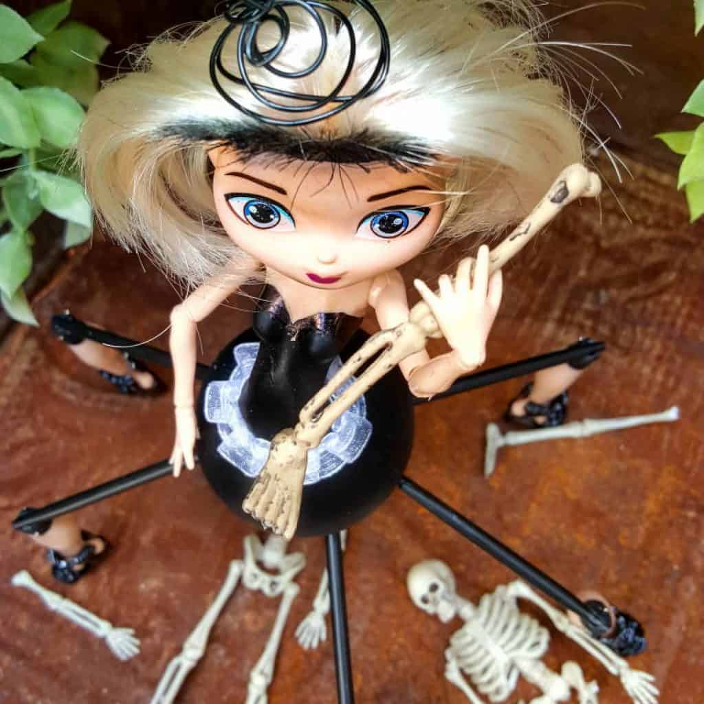 Do spiders freak you out? This easy to follow tutorial will show you how to give a cheap plastic doll a spider-girl makeover for Halloween that's a little freaky but oh so cute too #Halloweendecor #dollmakeover #spidergirl #acraftymix #halloweentutorial #halloweenDIY