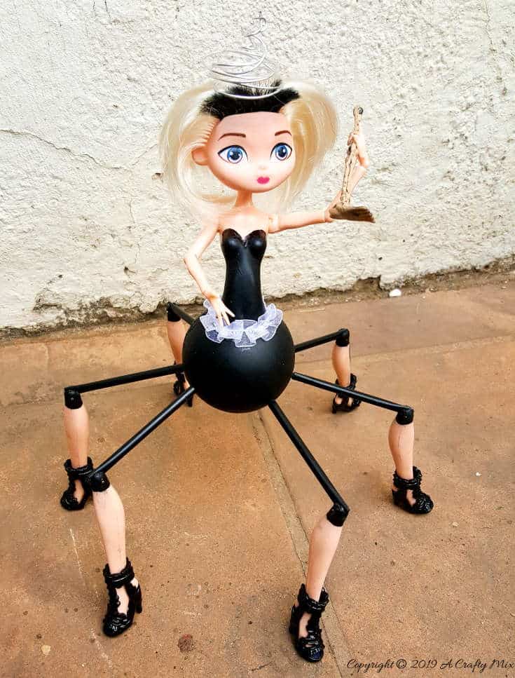 Do spiders freak you out? This easy to follow tutorial will show you how to give a cheap plastic doll a spider-girl makeover for Halloween that's a little freaky but oh so cute too #Halloweendecor #dollmakeover #spidergirl #acraftymix #halloweentutorial #halloweenDIY