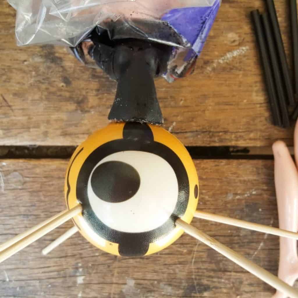 Glue the torso onto the rubber ball and insert skewers #Halloweendecor #dollmakeover #spidergirl #acraftymix #halloweentutorial #halloweenDIY