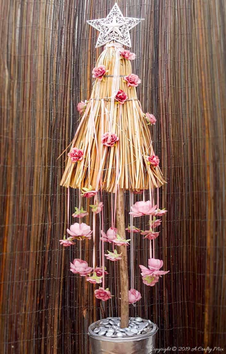 How to repurpose a broom into a Christmas tree. Fun Festive Decor with a twist #broomrepurpose #broomchristmastree #acraftymix #broomdecor #christmastree #DIYChristmasTree