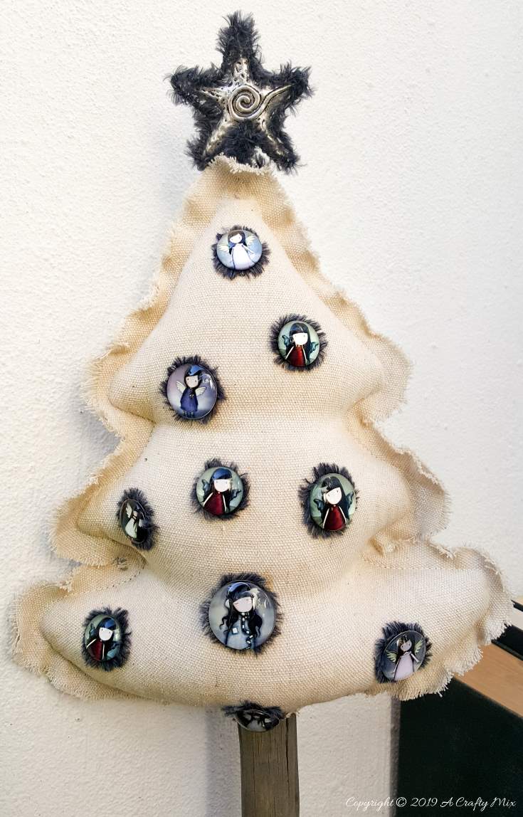 This Gorjuss inspired drop cloth Christmas tree doesn't even take an hour to make and it can be reused as a scatter cushion when the decorations come down. #gorjuss #gorjussart #gorjussgirl #santorogorjuss #acraftymix #dropclothrepurpose #dropclothChristmas #dropclothDIY #dropclothcrafts