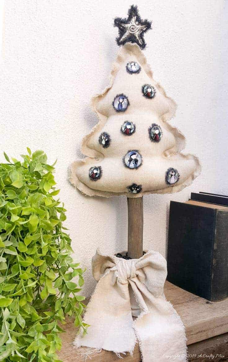 This Gorjuss inspired drop cloth Christmas tree doesn't even take an hour to make and it can be reused as a scatter cushion when the decorations come down. Perfect decor for small spaces #gorjuss #gorjussart #gorjussgirl #santorogorjuss #acraftymix #dropclothrepurpose #dropclothChristmas #dropclothDIY #dropclothcrafts #freepattern