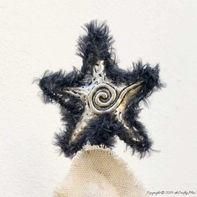 Add a star on the top of the drop cloth Christmas tree #gorjuss #gorjussart #gorjussgirl #santorogorjuss #acraftymix #dropclothrepurpose #dropclothChristmas #dropclothDIY #dropclothcrafts