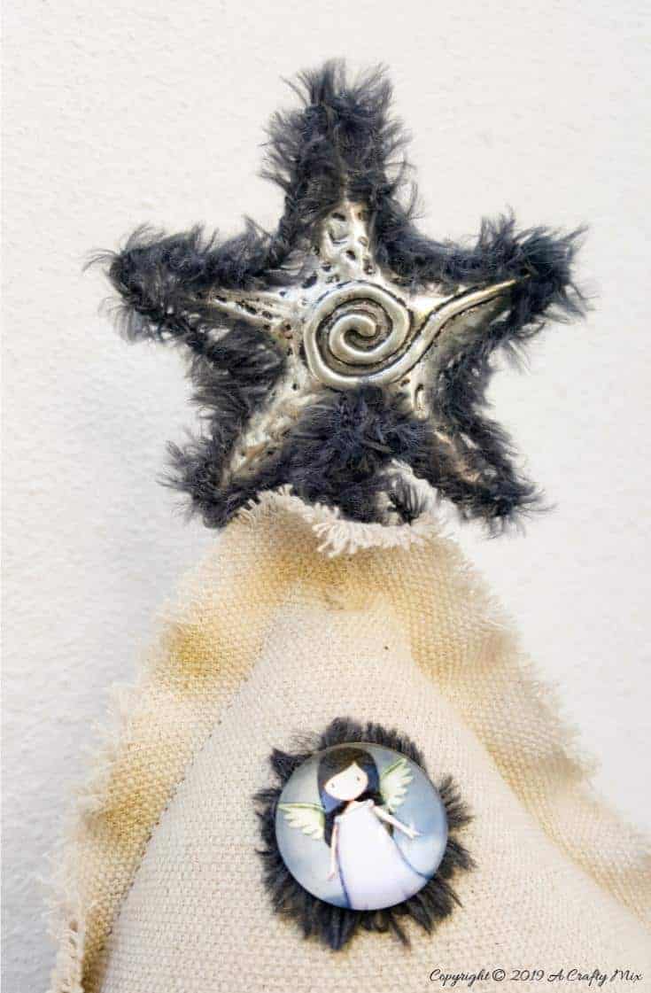 Add a star on the top of the drop cloth Christmas tree #gorjuss #gorjussChristmas  #gorjussgirl #santorogorjuss #acraftymix #dropclothrepurpose #dropclothChristmas #dropclothDIY #dropclothcrafts