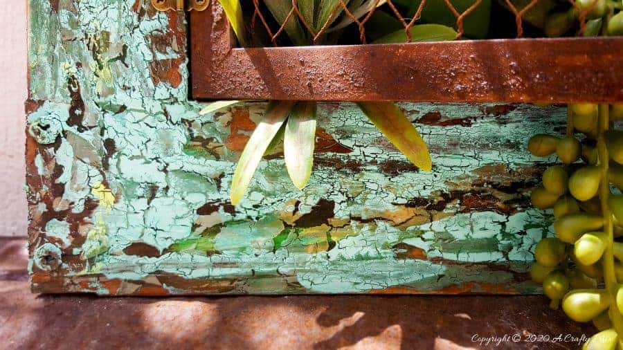 Close up of the "Cracked Up" blue Unicorn Spit Paint Effect #UnicornSpitTechniques #Windowplanter #UnicornSpitRustEffect #FauxRustEffect #ACraftyMix #PictureFrameRepupose #UnicornSpitIdeas #PictureFrameCrafts #SpillingPlanter