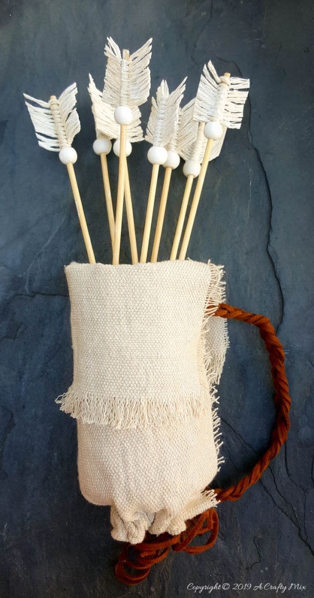 Make this no-sew quiver full of macram&eacute; arrows for Valentine&rsquo;s Day using empty soda cans. It&rsquo;s a fun gift idea and you can use it all year round in your home d&eacute;cor too. It only take an hour to make and you don&rsquo;t need any fancy tools or equipment either. #VintageValentine #TinCanRecycle #ValentineGiftIdea #QuiverArrows #AcraftyMix #HomeDecor #MacrameArrow