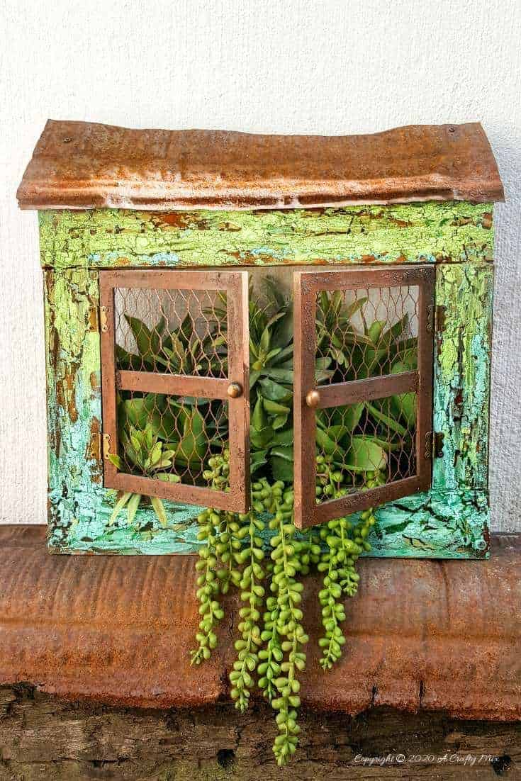 Full tutorial how to make this gorgeous "Cracked Up" Unicorn SPiT planter with plastic picture frame windows. Includes how to get a rust effect with US #UnicornSpitTechniques #Windowplanter #UnicornSpitRustEffect #FauxRustEffect #ACraftyMix #PictureFrameRepupose #UnicornSpitIdeas #PictureFrameCrafts #SpillingPlanter