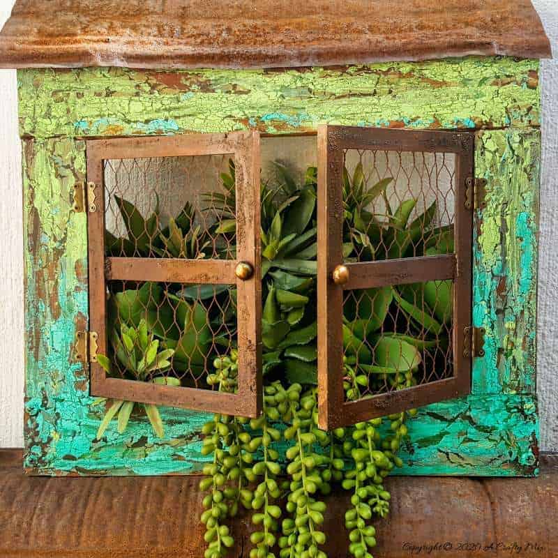 Full tutorial how to make this gorgeous "Cracked Up" Unicorn SPiT planter with plastic picture frame windows. Includes how to get a rust effect with US #UnicornSpitTechniques #Windowplanter #UnicornSpitRustEffect #FauxRustEffect #ACraftyMix #PictureFrameRepupose #UnicornSpitIdeas #PictureFrameCrafts #SpillingPlanter