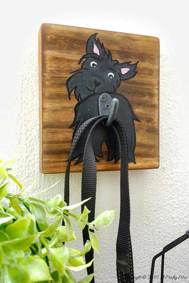 Make an adorable and easy DIY Dog Leash holder using a scrap piece of wood and craft paint. You and your fur baby will love it and the tutorial includes a free printable! #DIYDogLeash #Leashholderideas #WoodLeashHolder #ACraftyMix #FreePrintable #ScottishTerrier #PetLeashHolder #DIYLeashHolder