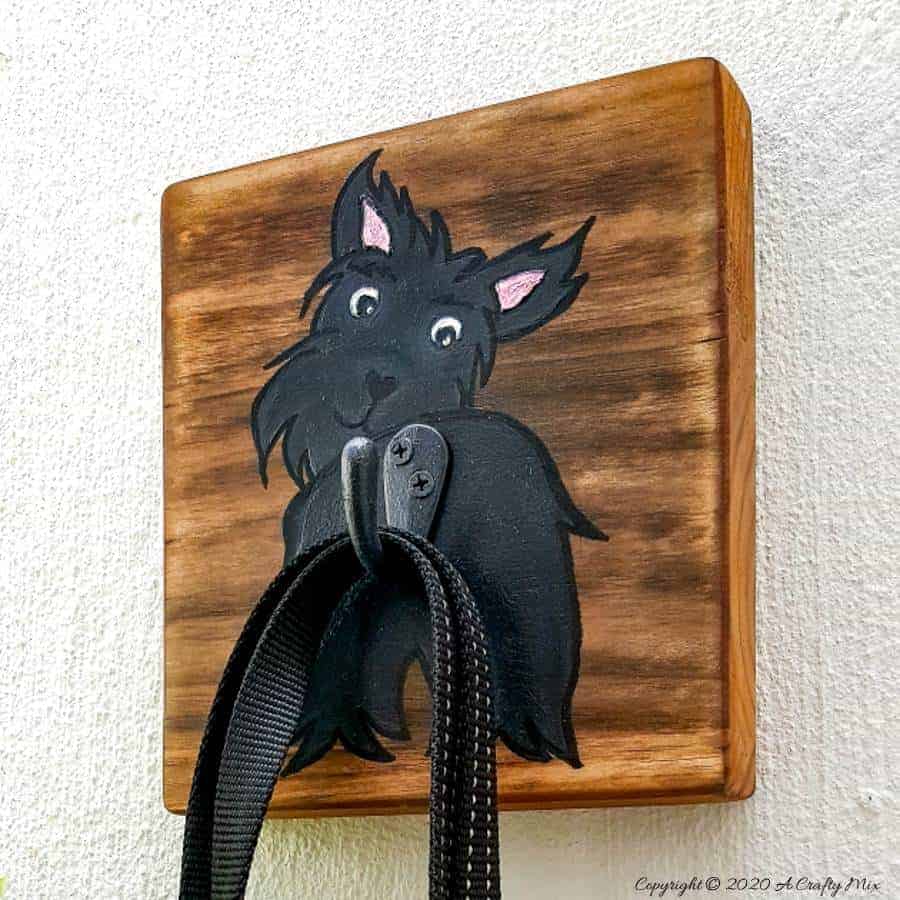 Make an adorable and easy DIY Dog Leash holder using a scrap piece of wood and craft paint. You and your fur baby will love it and the tutorial includes a free printable! #DIYDogLeash #Leashholderideas #WoodLeashHolder #ACraftyMix #FreePrintable #ScottishTerrier #PetLeashHolder #DIYLeashHolder