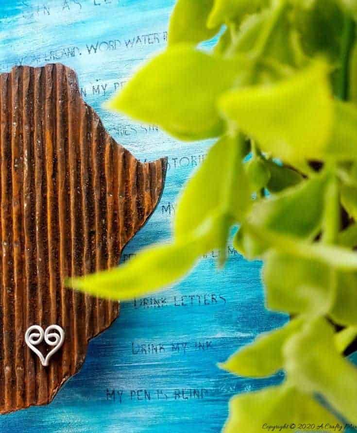Mixed media pieces are always fun to put together and the possibilities are endless. This tutorial will show you how to make cardboard look like a rusty sheet of metal and turn your mixed media into a night light. #mixedmedia #mixedmediatutorial #DIYNightLight #ACraftyMix #fauxrust #Africa #HomeDecor
