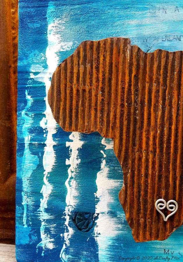 Mixed media pieces are always fun to put together and the possibilities are endless. This tutorial will show you how to make cardboard look like a rusty sheet of metal and turn your mixed media into a night light. #mixedmedia #mixedmediatutorial #DIYNightLight #ACraftyMix #fauxrust #Africa #HomeDecor
