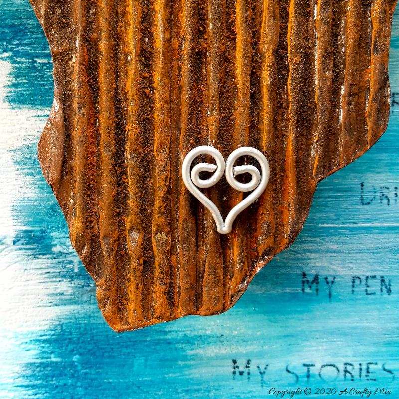 Mixed media pieces are always fun to put together and the possibilities are endless. This tutorial will show you how to make cardboard look like a rusty sheet of metal and turn your mixed media into a night light. #mixedmedia #mixedmediatutorial #DIYNightLight #ACraftyMix #fauxrust #Africa #HomeDecor